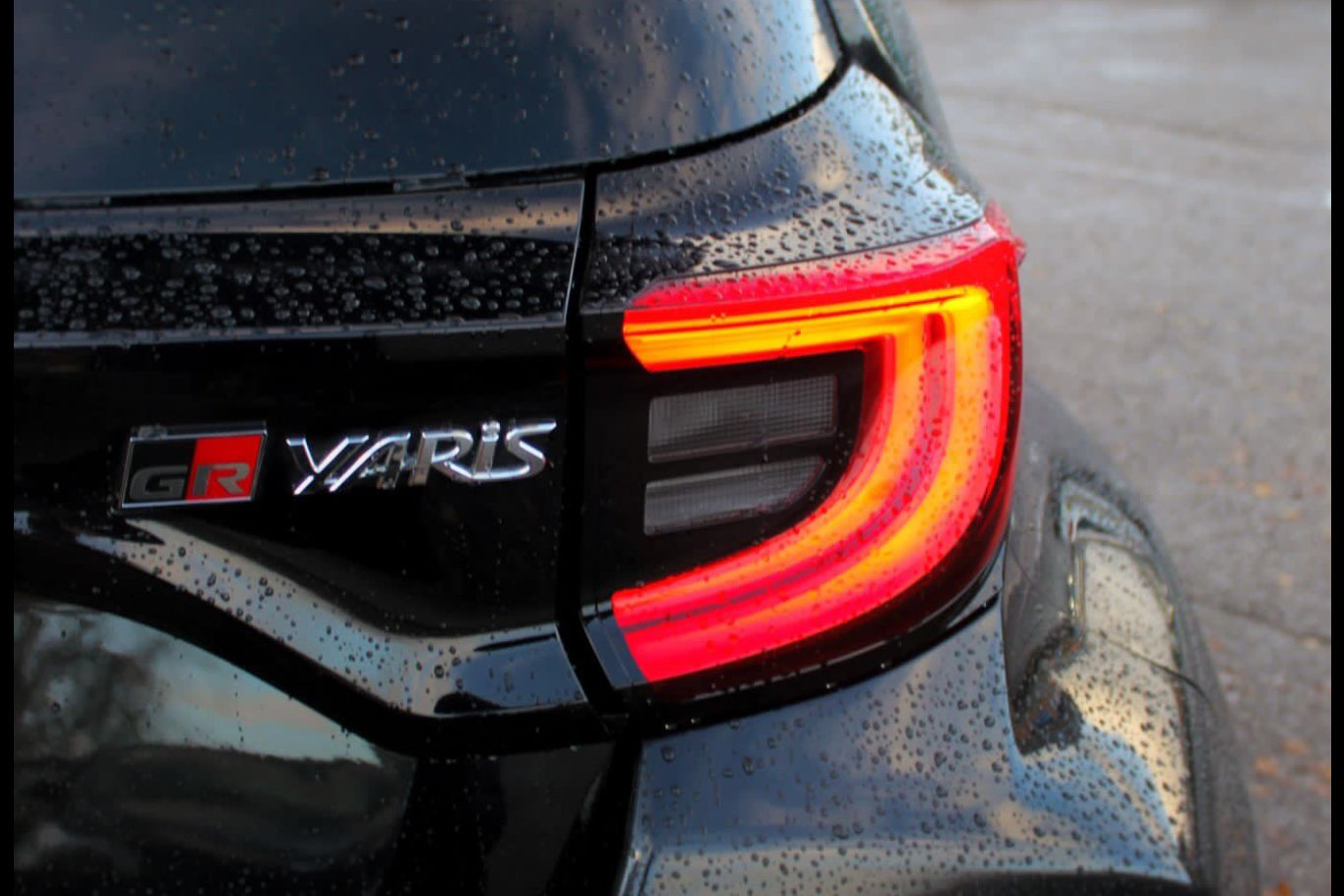 Close-up of a black Toyota Yaris car's rear with visible branding.